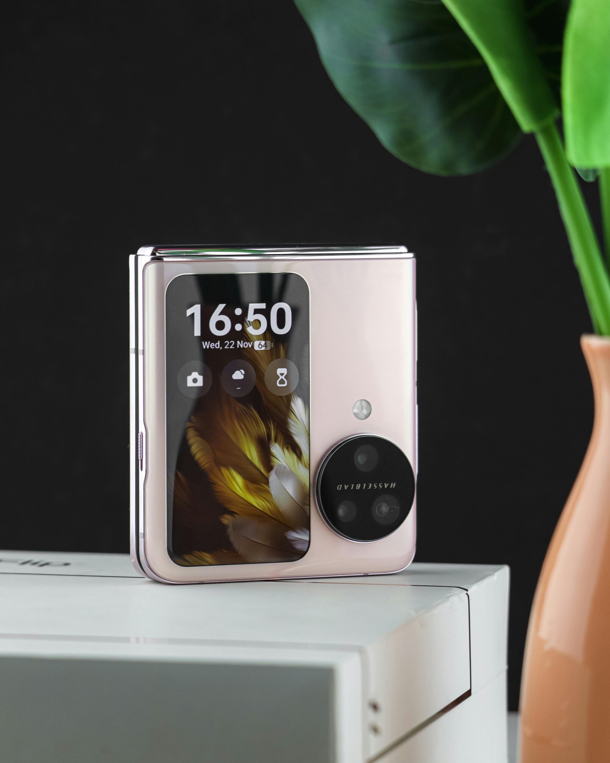 A stylish and sleek smartphone displayed on stacked boxes, embodying modern technology and design.